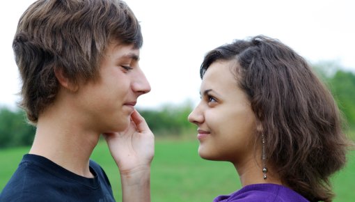 Photo of a young man and woman looking at each other