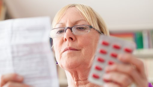 Photo of a woman reading a package insert