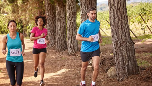 Photo of three people running outdoors