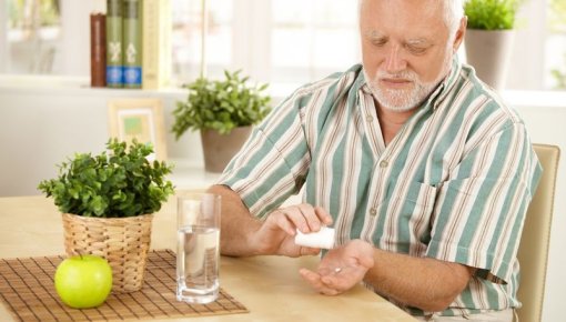 Photo of a man taking his medicine