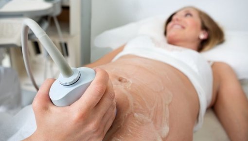 Photo of a pregnant woman having an ultrasound scan