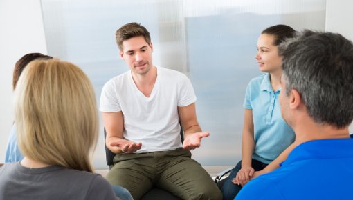 Photo of a man at a self-help group meeting