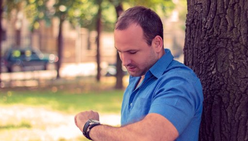 Photo of a man checking his watch