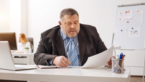 Photo of an overweight man at an office desk