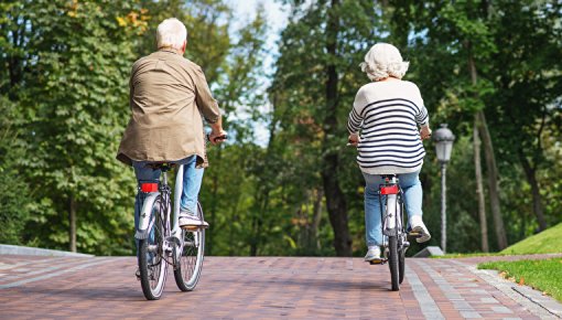 Photo of an elderly couple cycling