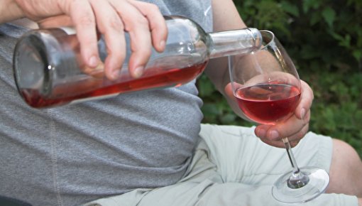 Photo of a man drinking wine