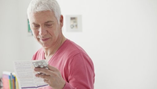 Photo of a man reading a package insert