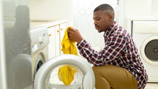 Photo of a man doing laundry