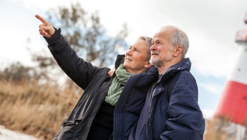 Photo of an older couple taking a walk on the beach