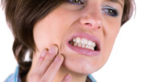 Photo of a woman touching her cheek in pain