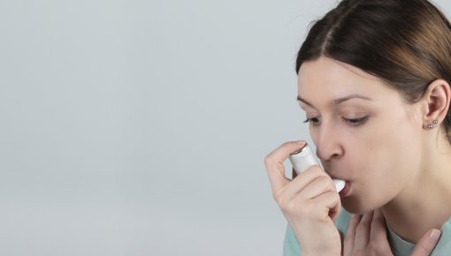 Photo of a woman using an inhaler