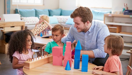 Photo of children playing a game with their kindergarten teacher