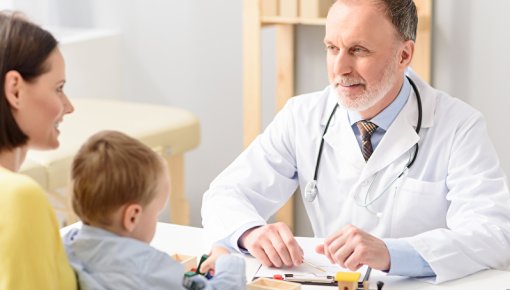 Photo of a mother and her son talking to their doctor