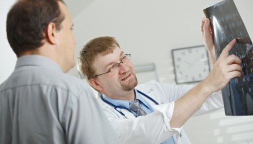 Photo of a patient and doctor with x-ray image