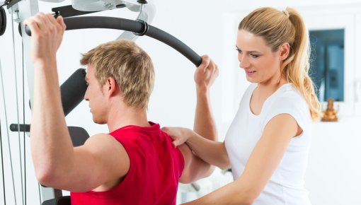 Photo of a patient doing back exercises with the help of a physical therapist