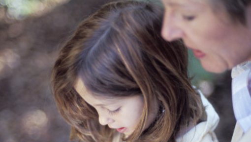 Photo of a mother and child reading a book