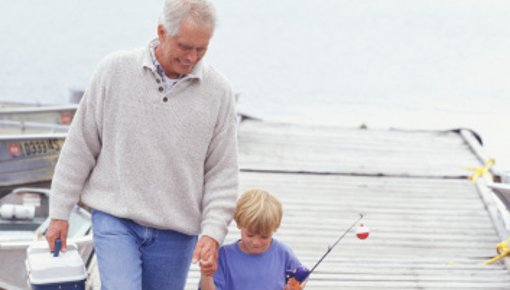 Photo of grandfather and grandson after going fishing