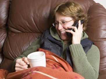 Photo of a woman on a sofa chatting on the phone