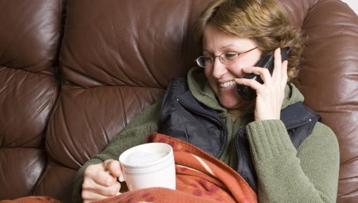 Photo of a woman on a sofa chatting on the phone