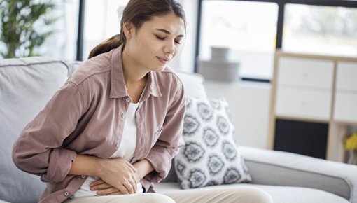 Photo of a girl holding her belly in pain