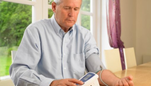 Photo of a man measuring his blood pressure