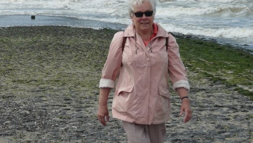 Photo of a woman walking on the beach