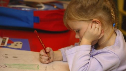 Photo of a young girl drawing