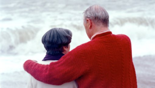 Photo of a couple sitting at the beach