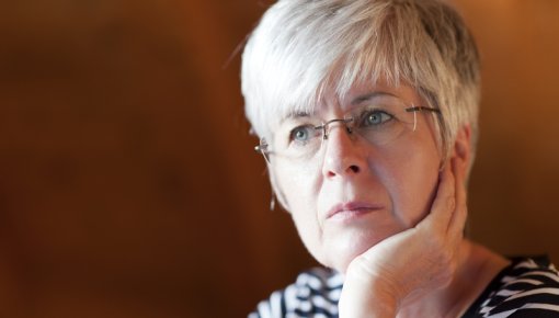 Photo of a woman resting her chin on her hand