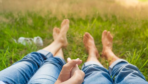 Photo of two people lying in grass