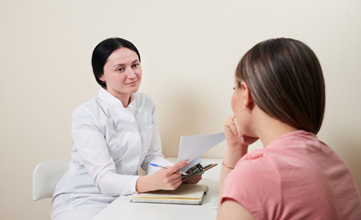 Photo of a woman speaking to her doctor