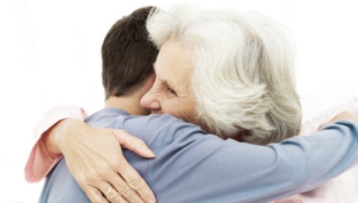 Photo of a grandmother hugging her grandson