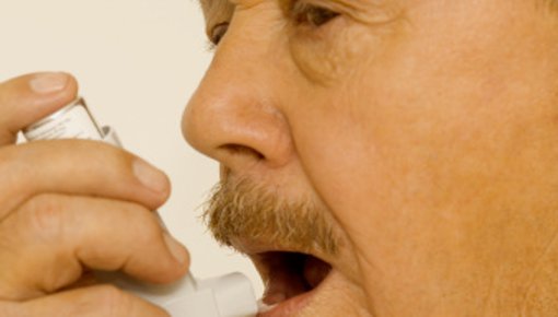 Photo of a man inhaling medicine