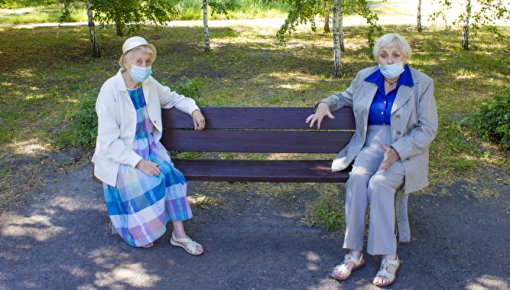 Photo of two elderly women sitting in the park