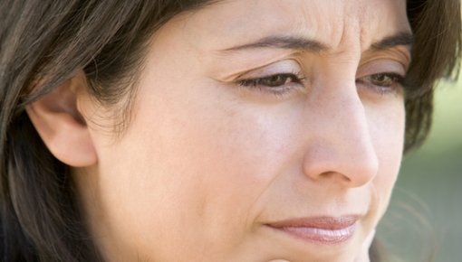 Photo of a woman holding her chin