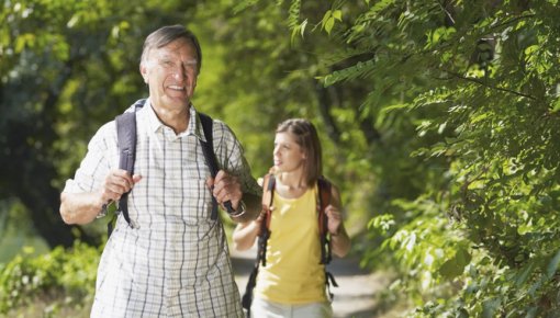 Photo of a father hiking with his daughter