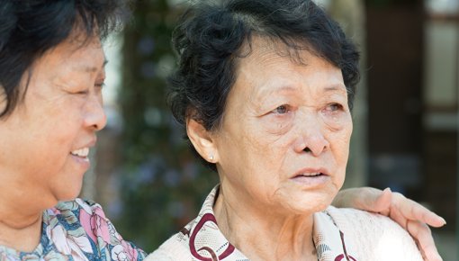 Woman with her arms around an older woman