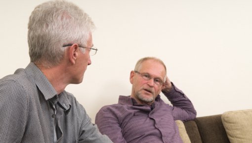 Photo of two men talking