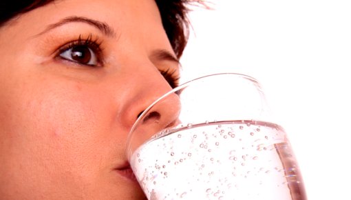 Photo of a woman with a glass of water