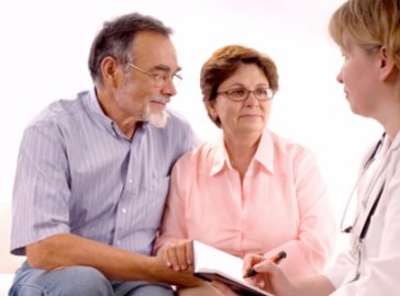 Photo of an older couple and a doctor