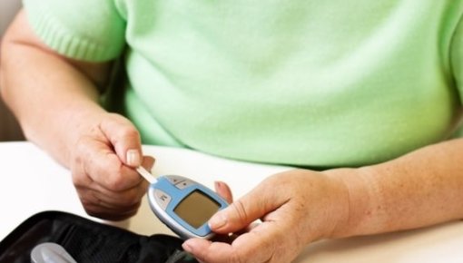 Photo of a woman measuring her blood sugar