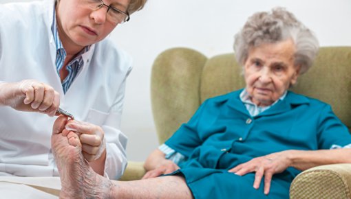 Photo of a patient having her feet examined by a foot specialist