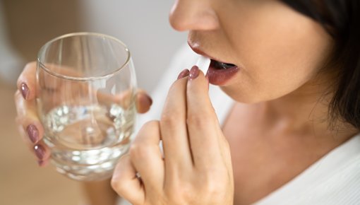 Photo of woman taking medication