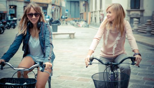 Photo of two women cycling outdoors