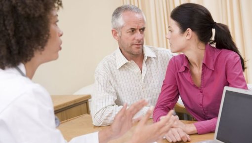 Photo of a couple talking with a doctor