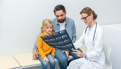 Photo of a father and daughter talking to a doctor