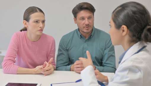 Photo of two parents talking to a doctor