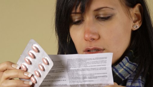 Photo of woman reading a package insert
