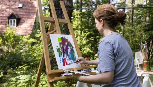 Photo of a woman painting a picture