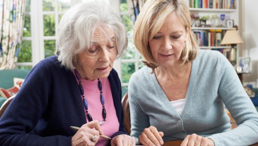 Photo of two women filling out forms